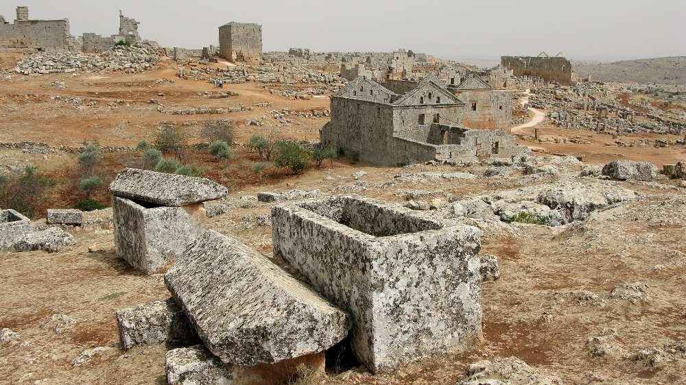 Cut-stone ruins and carved sarcophagi at Serjilla in the limestone hills of Idlib province, Syria