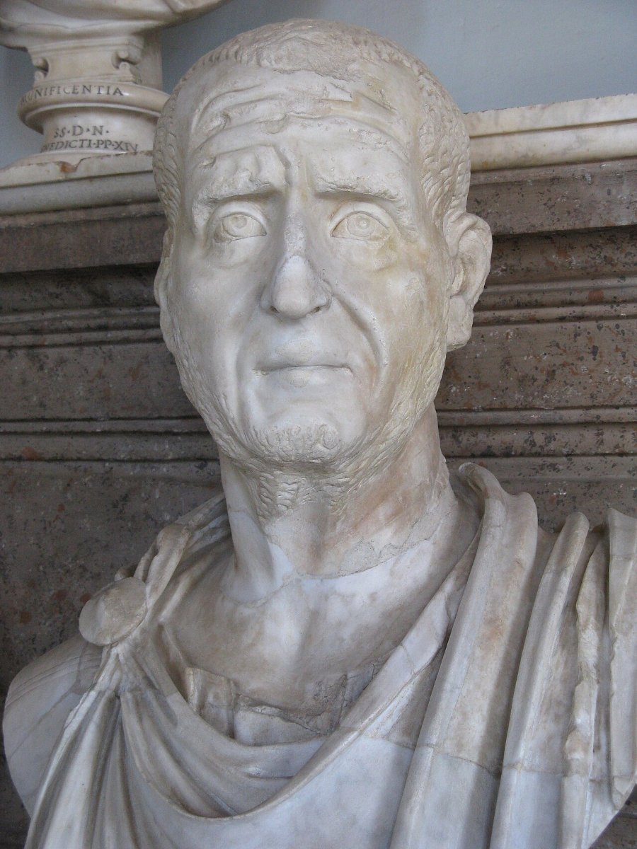 A marble portrait bust of the Roman emperor Trajan Decius, a lined, careworn face with close-cropped hair and stubble