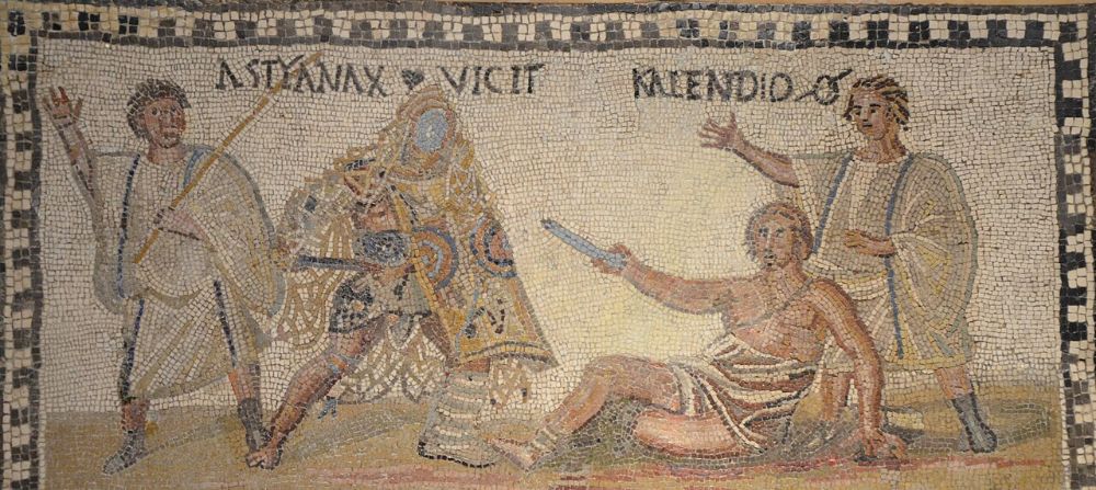 Roman mosaic of two gladiators flanked by officials, one fallen, with the Latin names Astyanax and Kalendio above them