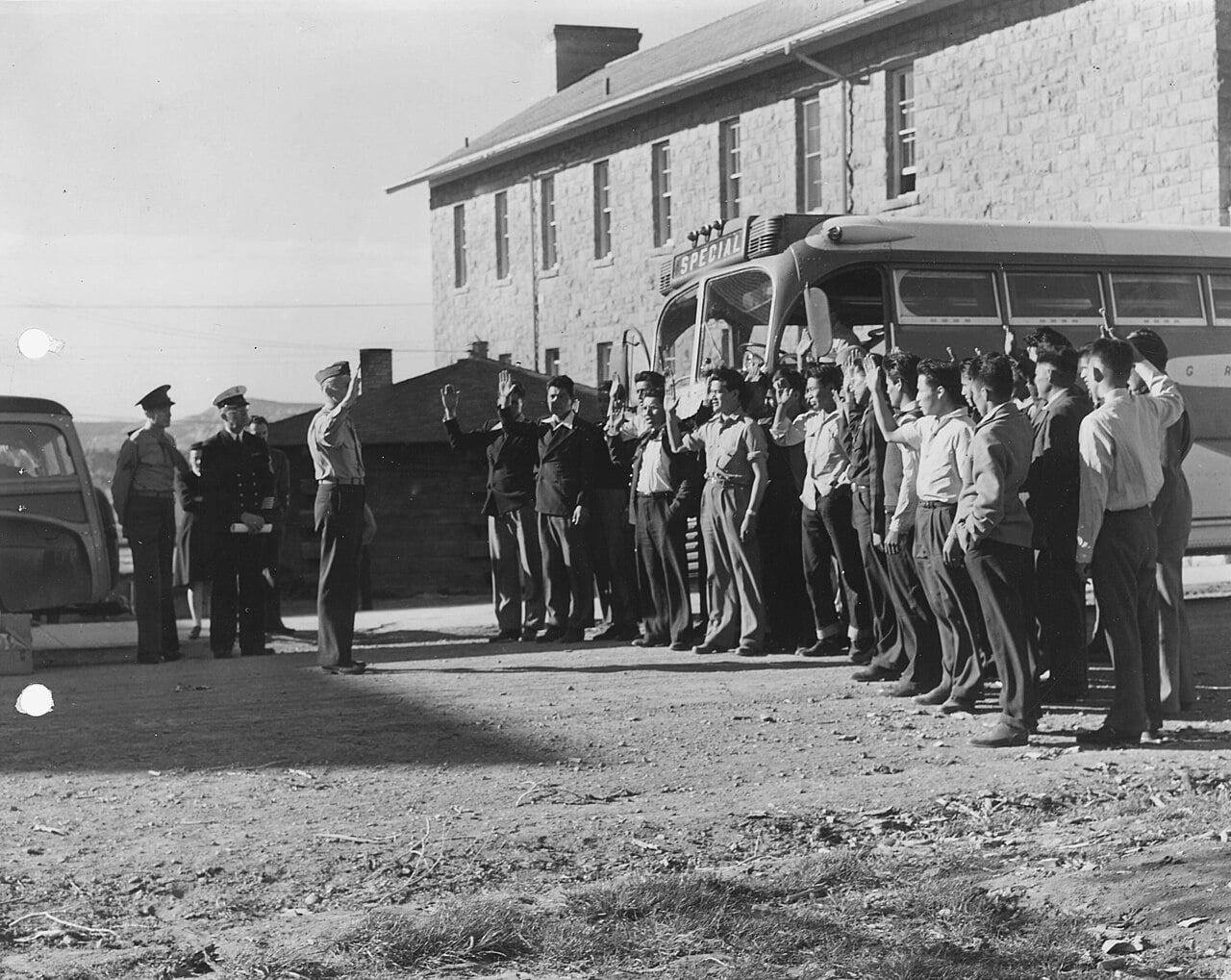 Rows of Navajo Marine recruits standing with right hands raised as they are sworn in