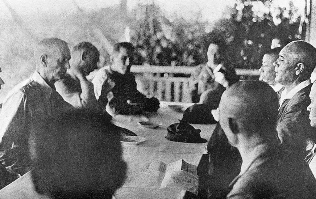 American and Japanese officers seated at a table during surrender negotiations