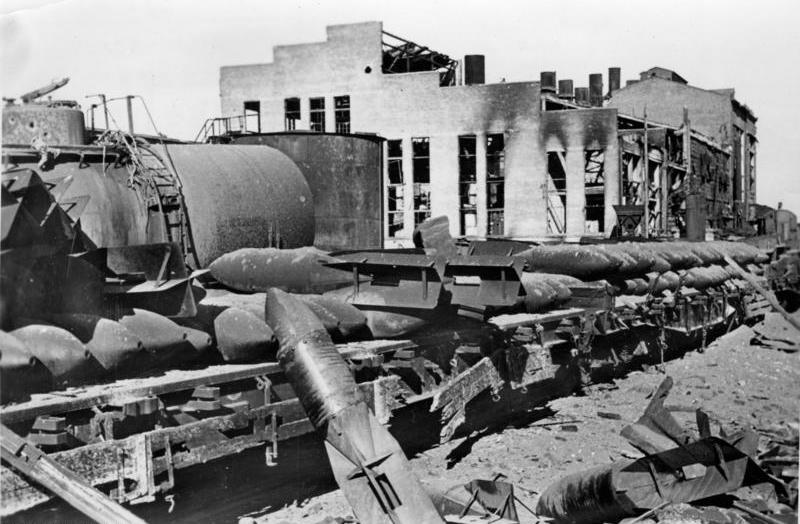 The wreckage of a large industrial building, girders and machinery buried in debris